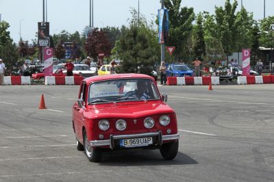 Front view of a classic red car with four circular headlights