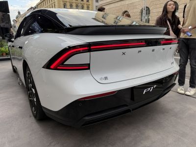 Rear view of sleek electric sedan with LED tail lights and aerodynamic design