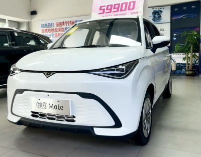 Front view of compact electric vehicle with sleek headlights and aerodynamic design