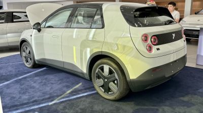 Rear side profile with distinctive round tail lights and modern trim design