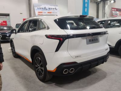 Rear design with distinct taillights and quad exhaust tips.