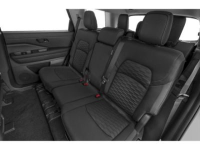 Rear seat interior with black leather and textured upholstery in an SUV