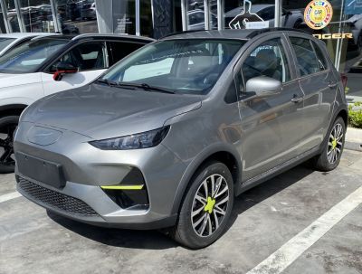 Compact electric hatchback with LED headlights and unique bright green wheel caps