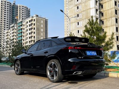 Rear and side view of sleek vehicle with modern taillights & alloy wheels