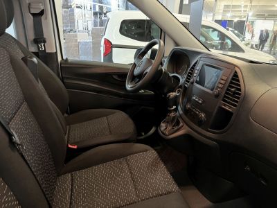 Interior front cabin with fabric seats, steering wheel, and dashboard