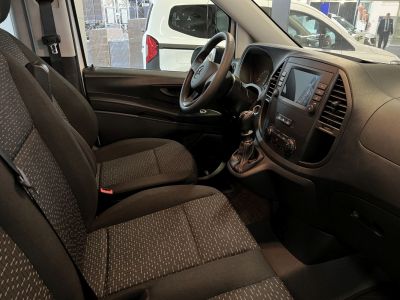 Van interior with dashboard, steering wheel, and upholstered seats