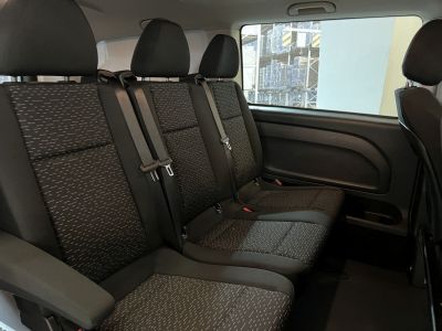 Spacious rear passenger seats with patterned upholstery and seat belts