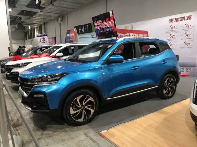Blue compact SUV with sporty wheels and modern headlights