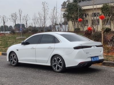 White sedan rear side with tinted windows and alloy wheels