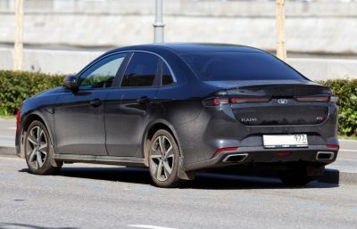 Rear and side view of sedan with slim tail lights and dual exhaust tips