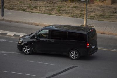 Side view of black long tourer van with tinted windows