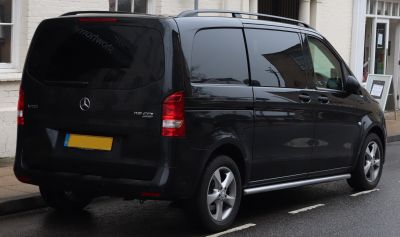 Rear side view of black van with tinted windows and alloy wheels