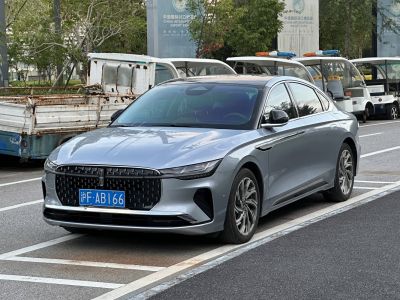 Sleek sedan with distinctive front grille and narrow LED headlights