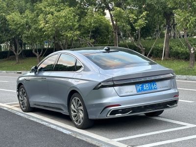 Rear view of sleek sedan with LED taillight bar and aerodynamic shape