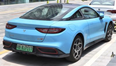 Rear view of electric coupe with sleek taillights and aerodynamic roofline