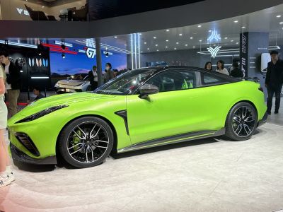 Sleek side profile of a green sport coupe with aerodynamic styling and alloy wheels