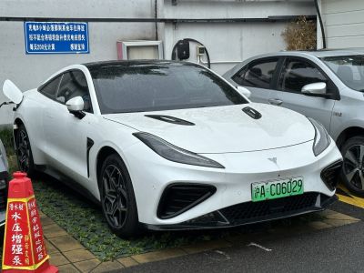 Front view of a white electric sports coupe with sleek headlights