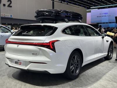 Rear LED tail lights and roof cargo box on modern white car