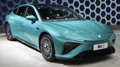 Aerodynamic electric sedan with sleek LED headlights and intricate alloy wheels