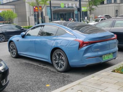 Sleek blue electric sedan with sharp rear light bar and aerodynamic shape