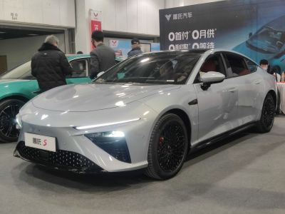 Gray electric sedan with narrow LED lights and black alloy wheels