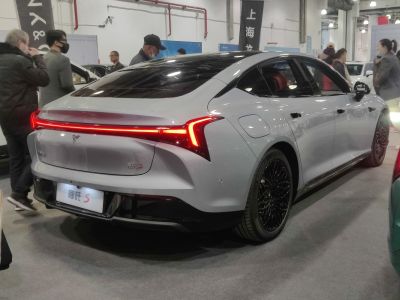 Sleek sedan rear with continuous LED tail lights and black multi-spoke wheels