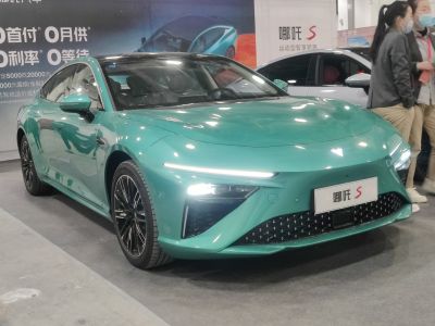 Sleek electric sedan front with LED daytime running lights and aerodynamic design