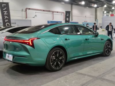 Rear view of electric sedan with LED light bar and aerodynamic design