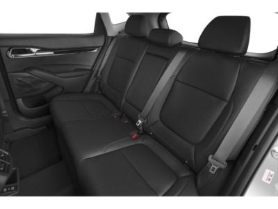 Rear black leather seats with seat belts in a modern car interior.