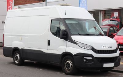 White high-roof panel van with black lower trim and steel wheels