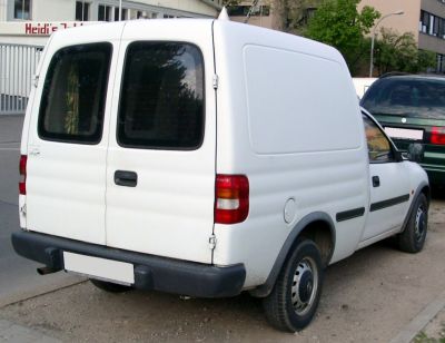 Compact white van rear view with dual rear doors and tinted windows