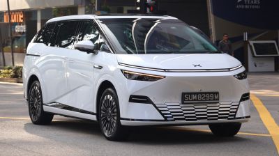 Sleek front exterior with sharp headlights and hexagonal grille design
