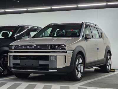 Front view of modern SUV with futuristic grille and LED headlights.