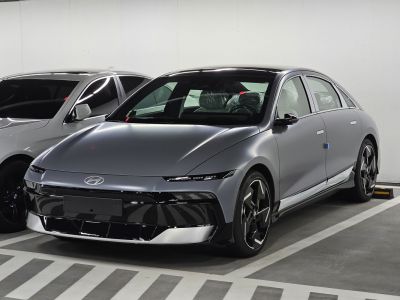 Sleek front-side view with modern headlights and aerodynamic shape