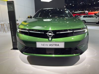 Front view with LED headlights and modern grille of a green vehicle.