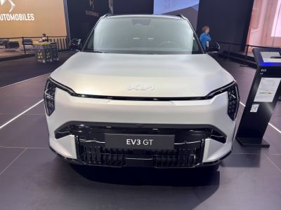 Front view of an electric SUV with sleek LED headlights and distinctive grille.