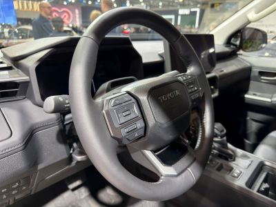 Close-up of a multifunction steering wheel with dashboard in vehicle interior