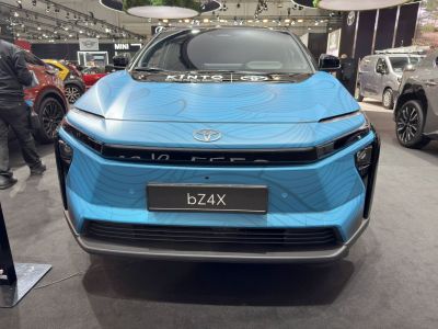 Front view of blue electric SUV with LED headlights and sleek grille