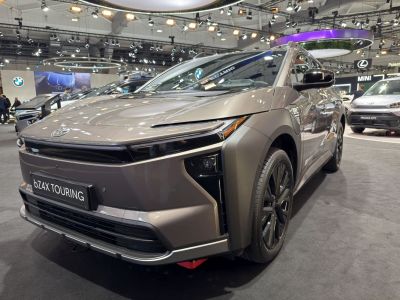 Front and side view of electric SUV with sleek headlights and aerodynamic body.