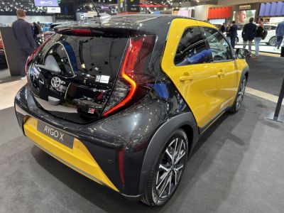 Rear view of compact hatchback with C-shaped LED tail lights and two-tone paint finish