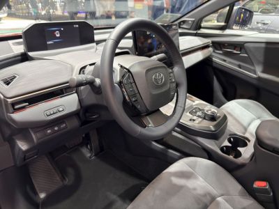 Steering wheel with integrated controls and dual digital display screens.
