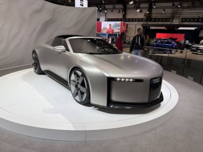 Futuristic electric coupe with angular LED headlights and smooth aerodynamic lines