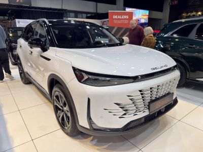 Sleek front grille and sharp headlights of a modern SUV.