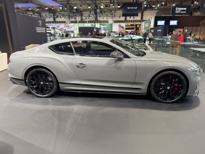 Sleek aerodynamic coupe side view with black alloy wheels