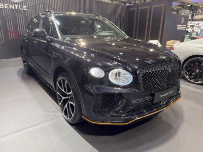 Luxury SUV front with diamond grille and multi-spoke alloy wheels