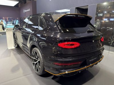 Rear view of luxury SUV with distinctive LED taillights and sporty rear spoiler.