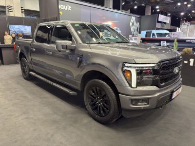 Side-front view of a modern pickup truck with black wheels and LED headlights