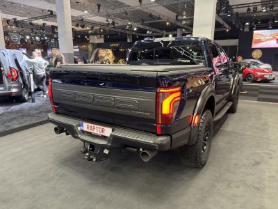 Rear view of 2024 pickup with tailgate, LED lights, and hitch
