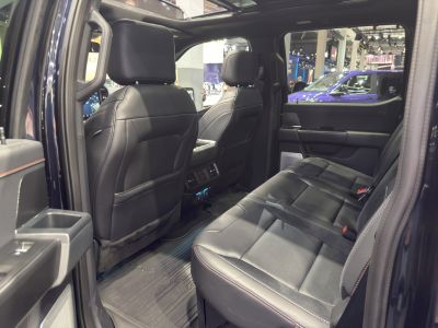 Spacious rear cabin with black leather seats and advanced features