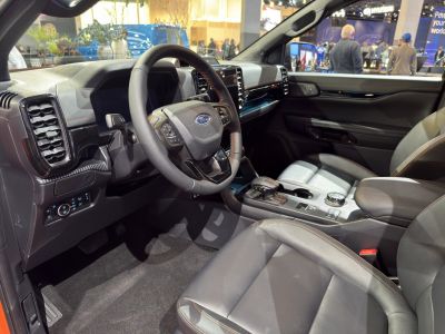 Modern steering wheel, dashboard, and center console with leather seats